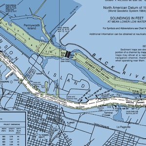 May include: A nautical chart of a river with a blue background and green islands. The chart shows depths in feet, buoys, and other navigational aids. The chart is titled "North American Datum of 1983 (World Geodetic System 1984)" and "Soundings in Feet at Mean Lower Low Water".