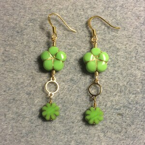 Lime green Czech glass puffy flower bead dangle earrings adorned with gold circle connectors and lime green Czech glass poppy beads. image 1