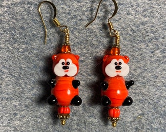 Opaque red and white lamp work teddy bear bead earrings adorned with opaque red Czech glass beads.