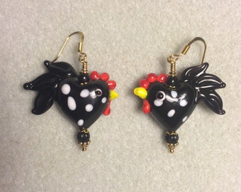 Black lampwork heart shaped rooster bead earrings adorned with black Czech glass beads.