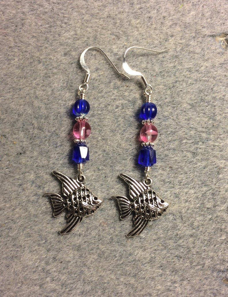 Silver angelfish charm dangle earrings adorned with cobalt blue and bright pink Czech glass beads.