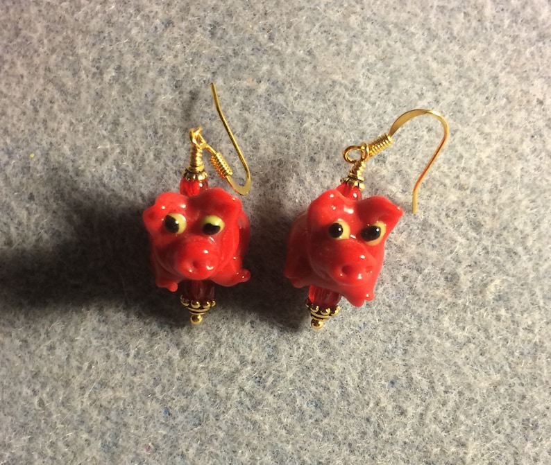 Small red lampwork pig bead earrings adorned with red Czech glass beads. Red lamp work pig earrings