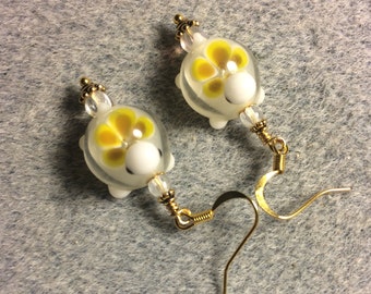 Yellow lampwork turtle bead earrings adorned with clear Czech glass beads.