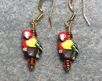 Small red, yellow, and green ceramic parrot bead earrings adorned with red Chinese crystal beads.