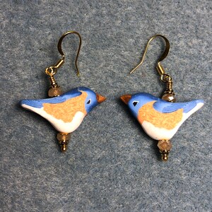 Milky light blue lampwork songbird bead earrings adorned with light blue Chinese crystal beads.