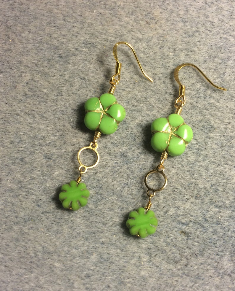Lime green Czech glass puffy flower bead dangle earrings adorned with gold circle connectors and lime green Czech glass poppy beads. image 2