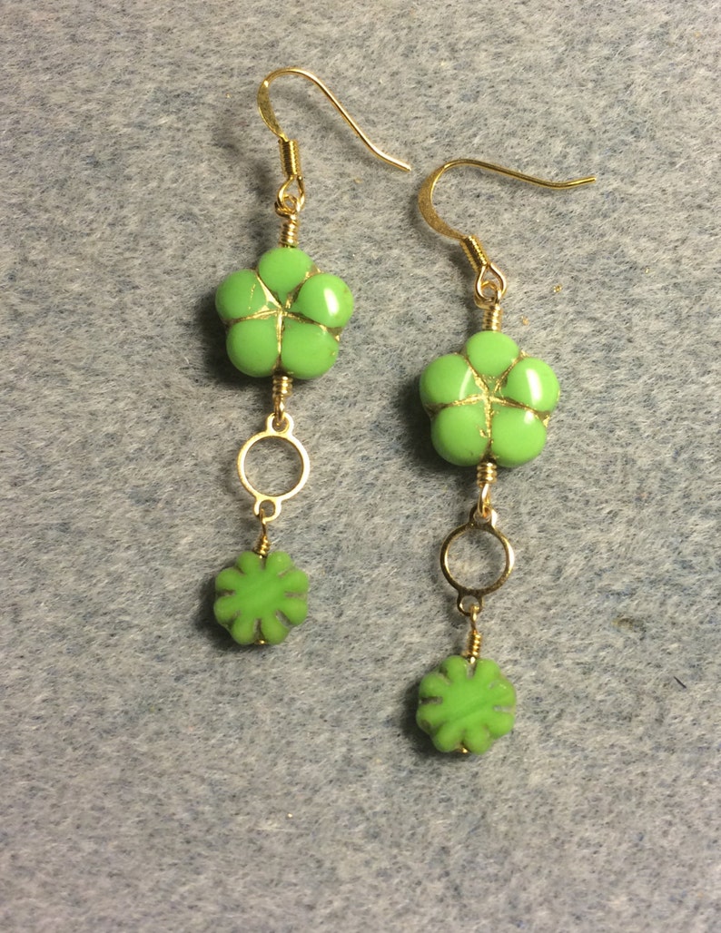 Lime green Czech glass puffy flower bead dangle earrings adorned with gold circle connectors and lime green Czech glass poppy beads. image 3