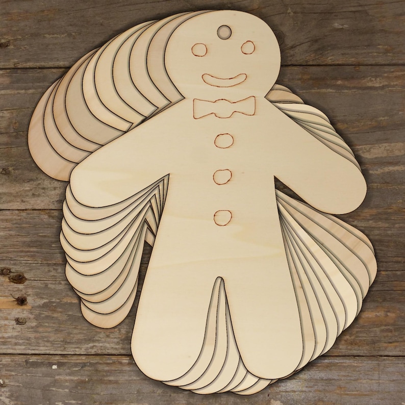 May include: A stack of 10 unfinished wooden gingerbread man decorations. The decorations are blank and ready to be painted or decorated.
