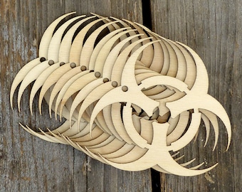 May include: A stack of laser-cut wooden biohazard symbols. The symbols are layered on top of each other, creating a three-dimensional effect.