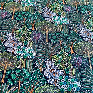 May include: A dark blue fabric with a repeating pattern of green, white, and orange stylized trees and flowers.