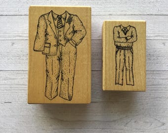 May include: Two wooden stamps with illustrations of people wearing suits. The larger stamp shows a person in a suit with a tie and a pocket square. The smaller stamp shows a person in a suit with a sweater.