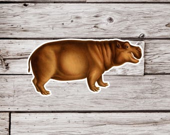 Könnte beinhalten: Ein brauner Hippo-Aufkleber mit weißem Rand. Der Hippo ist im Profil mit einem Lächeln dargestellt. Der Aufkleber befindet sich auf einer verwitterten, hellgrauen Holzoberfläche.