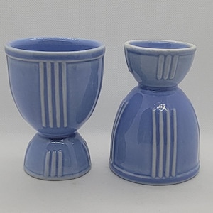 May include: A white ceramic mug with a black handle and the text "But First, Coffee" in a handwritten style. The mug is on a white surface. The mug is 4 inches tall.
