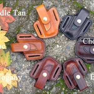 May include: Seven leather knife sheaths in different colours: Saddle Tan, Cognac, Mahogany, Brown, Chocolate, Black. Each sheath has a belt loop and a snap closure.
