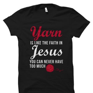 May include: Black t-shirt with white text that reads "Yarn is like the faith in Jesus. You can never have too much."  A red yarn ball is pictured below the text.