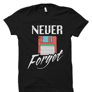 May include: Black t-shirt with white text that reads "NEVER Forget" and a retro floppy disk graphic.
