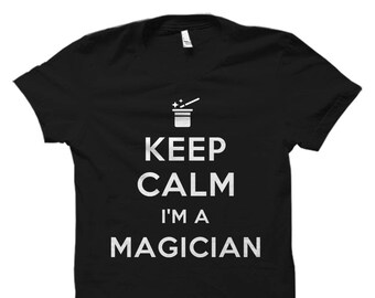 May include: Black t-shirt with white text that reads "Keep Calm I'm a Magician". The text is in a vintage style font. A small graphic of a magic hat and wand is above the text.