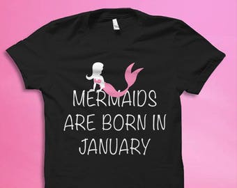 May include: Black t-shirt with a pink mermaid graphic and the text "Mermaids are born in January".