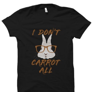 May include: Black t-shirt featuring a white rabbit wearing brown glasses and the text "I don't carrot all".