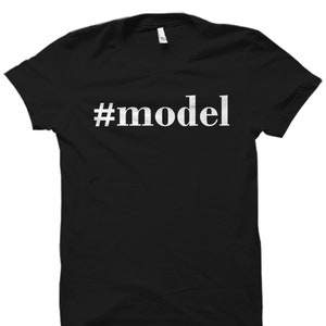 May include: Black t-shirt with white text that reads "#model"