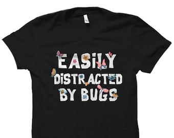 May include: Black t-shirt with the text "Easily Distracted By Bugs" in white. The text is surrounded by colorful butterflies, flowers, and bees.