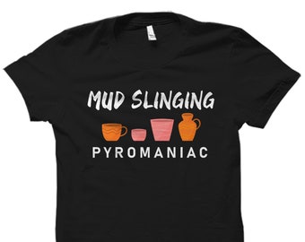 May include: Black t-shirt with white text that reads "Mud Slinging Pyromaniac". The text is centered on the shirt and is surrounded by four small illustrations of pottery.