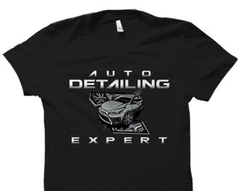 May include: Black t-shirt with a white graphic design featuring a car and the text "AUTO DETAILING EXPERT".