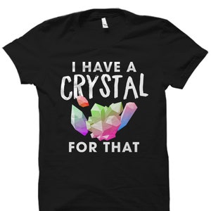May include: Black t-shirt with white text that reads "I have a crystal for that". A colorful crystal graphic is above the text.