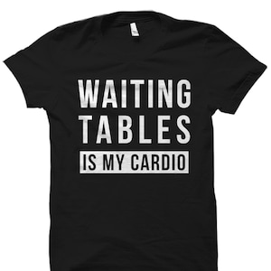 May include: Black t-shirt with white text that reads "Waiting tables is my cardio".