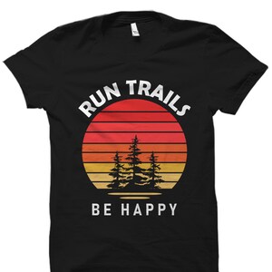 May include: Black t-shirt with a retro sunset graphic and the text "Run Trails Be Happy".