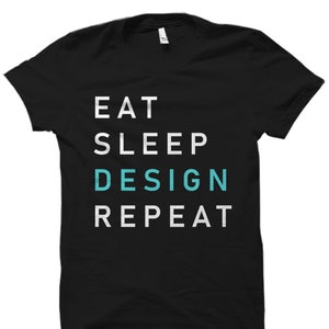 May include: Black t-shirt with white text that reads "Eat Sleep Design Repeat". The word "Design" is in teal.