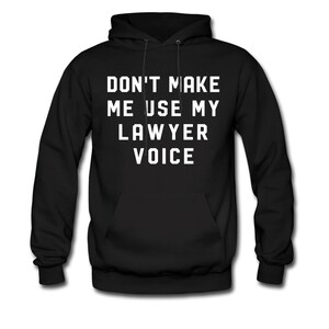 May include: Black hooded sweatshirt with the text "Don't make me use my lawyer voice" in white.