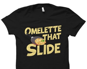 May include: Black t-shirt with a white graphic of a frying pan with an omelette and the text "Omelette That Slide".