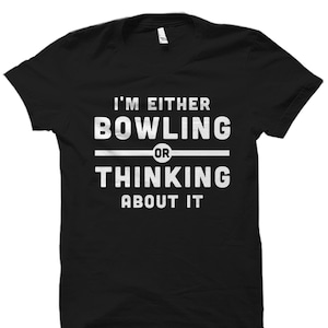 May include: Black t-shirt with white text that reads "I'm either bowling or thinking about it."