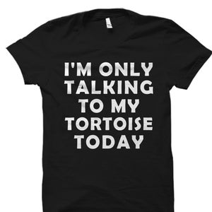 May include: Black t-shirt with white text that reads "I'm only talking to my tortoise today."