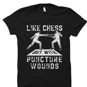 May include: Black t-shirt with white text that reads "Like chess but with puncture wounds". Two fencers are depicted in white fencing uniforms, holding swords and facing each other.