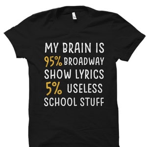 May include: Black t-shirt with white text that reads "My brain is 95% Broadway show lyrics 5% useless school stuff".