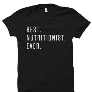 May include: Black t-shirt with white text that reads "BEST. NUTRITIONIST. EVER."
