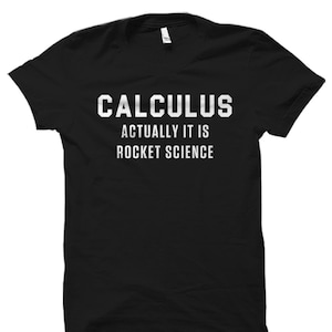 May include: Black t-shirt with white text that reads "Calculus Actually It Is Rocket Science."