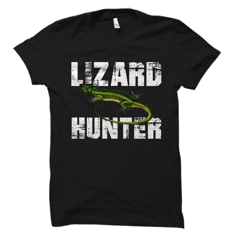 May include: Black t-shirt with a white distressed graphic of a green lizard and the text "Lizard Hunter".