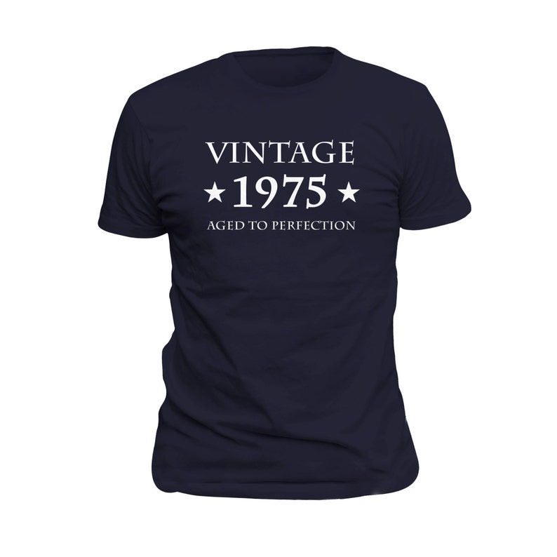 May include: A navy blue t-shirt with white text that reads "Vintage *1975* Aged to Perfection".