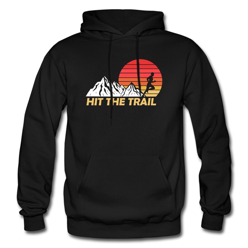 May include: Black hooded sweatshirt with a retro-style graphic of a person running on a mountain trail with a sunset in the background. The text "HIT THE TRAIL" is printed below the graphic.