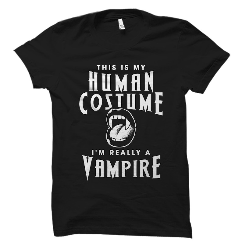 May include: Black t-shirt with white text that reads "This is my human costume I'm really a vampire" with a white graphic of a vampire's mouth with fangs.