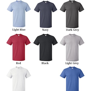 May include: A selection of t-shirt colors, including light blue, navy, dark grey, red, black, light grey, white, and blue.
