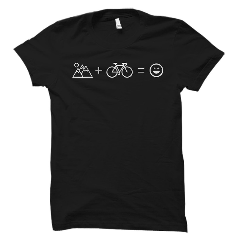 May include: Black t-shirt with white text that reads "Mountains + Bike = Happy". The text is in a simple, modern font.