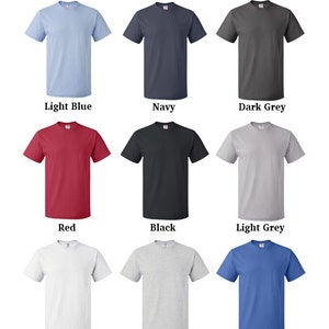 May include: Nine different color t-shirts displayed on a white background. The colors are light blue, navy, dark grey, red, black, light grey, white, ash, and blue.