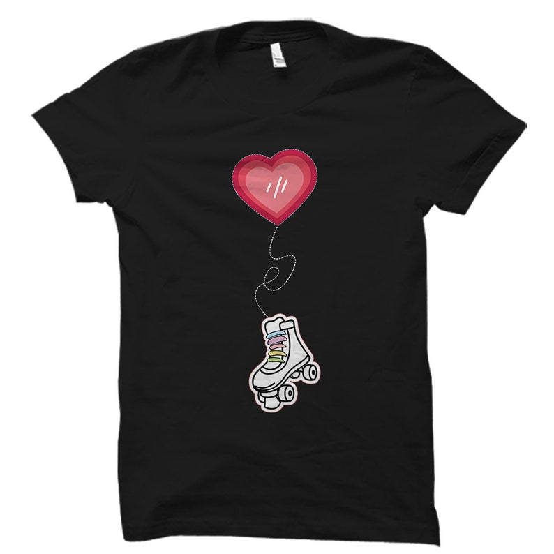 May include: Black t-shirt featuring a red heart balloon and a white roller skate with rainbow laces. The heart has the text "///" inside.