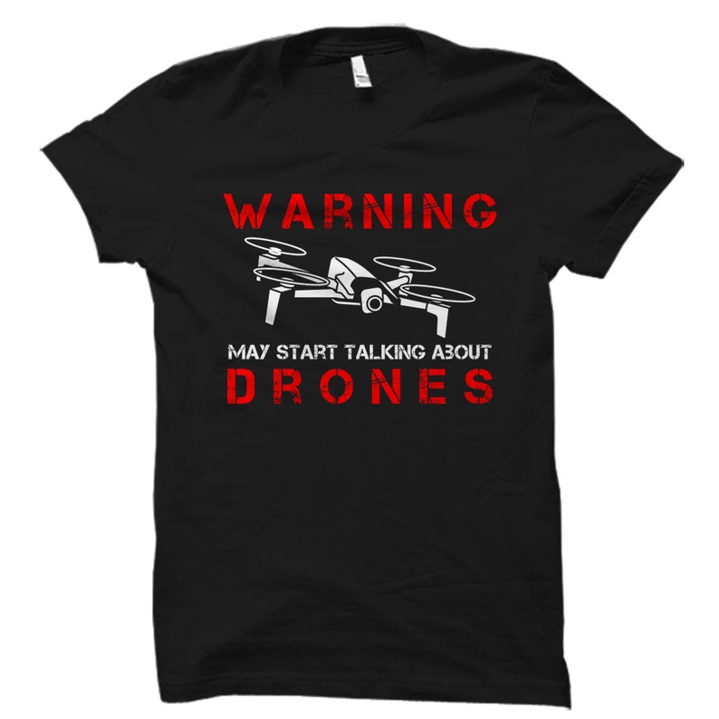 May include: Black t-shirt with a white drone graphic and red text that reads "WARNING MAY START TALKING ABOUT DRONES".