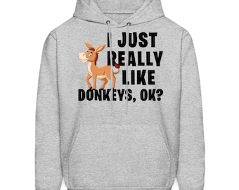 Puede incluir: Una sudadera con capucha gris con un burro de dibujos animados y el texto "Me gustan mucho los burros, ¿de acuerdo?"