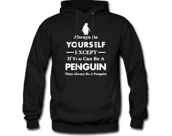 May include: Black hooded sweatshirt with a white penguin graphic and the text "Always Be Yourself - Except If You Can Be A Penguin Then Always Be A Penguin".